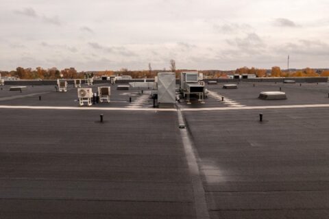 Built-up roof system on a commercial building by Bryan Exteriors