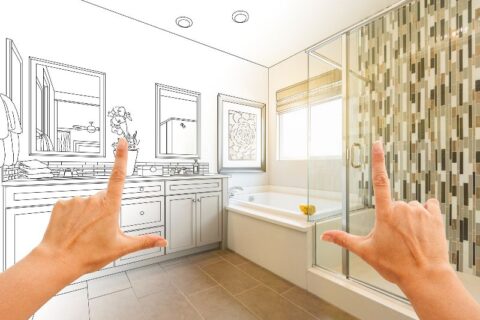 Hands framing and imagining a bathroom remodel by Bryan Exteriors