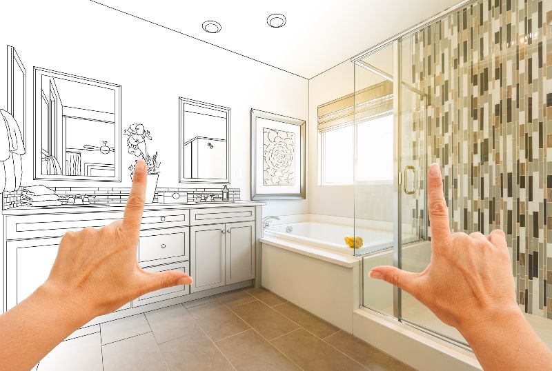 Hands framing and imagining a bathroom remodel by Bryan Exteriors