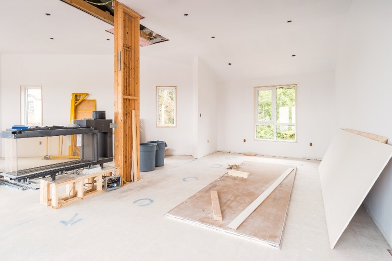 Family room being renovated with drywall on the floor by Bryan Exteriors