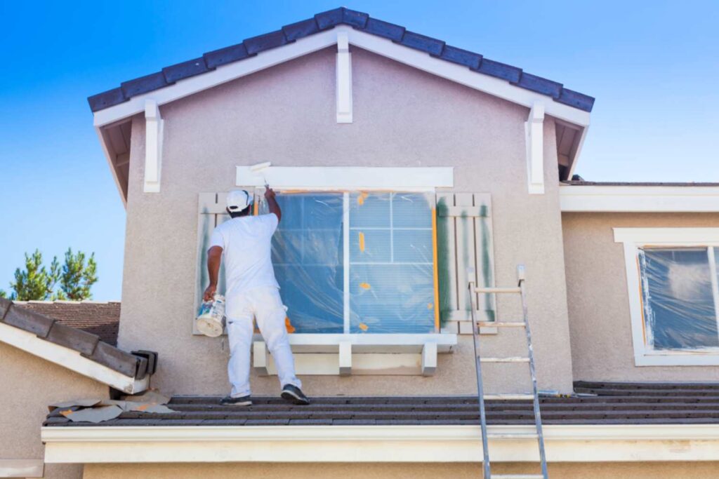 A Painter Painting the Home Exterior.